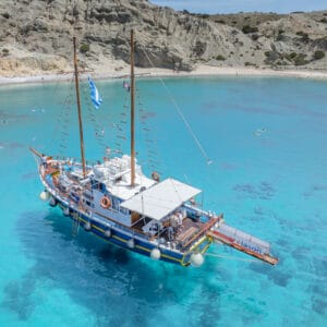 Aerial drone view of sandy beach with turquoise waters in Small Cyclades